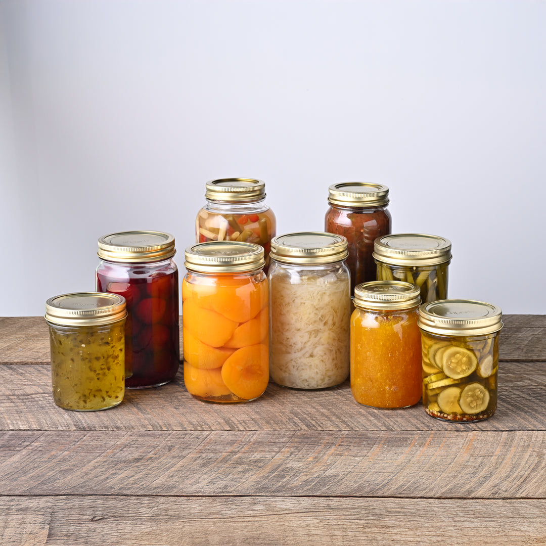 Wide mouth glass canning jar with metal lid from Superb Superb brand wide mouth mason jars stacked neatly High-quality canning jars for food storage Superb jars supporting sustainable food prep Fresh peaches preserved in wide mouth jars Assorted sizes of Superb canning jars Durable wide mouth jars made for home canning Superb canning jar set with both lid sizes Rustic kitchen shelf with Superb jars Superb jars used in farmhouse food prep
