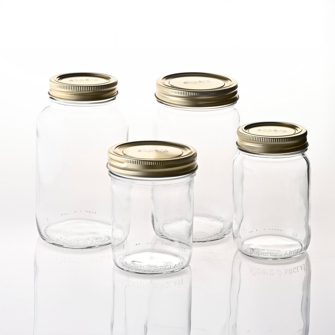 Wide mouth glass canning jar with metal lid from Superb Assorted sizes of Superb canning jars Regular mouth canning jar set on kitchen counter Regular mouth canning jar with airtight lid High-quality canning jars for food storage Durable wide mouth jars made for home canning Superb canning jar set with both lid sizes Standard regular mouth lid on matching jar Jar size variety offered by Superb