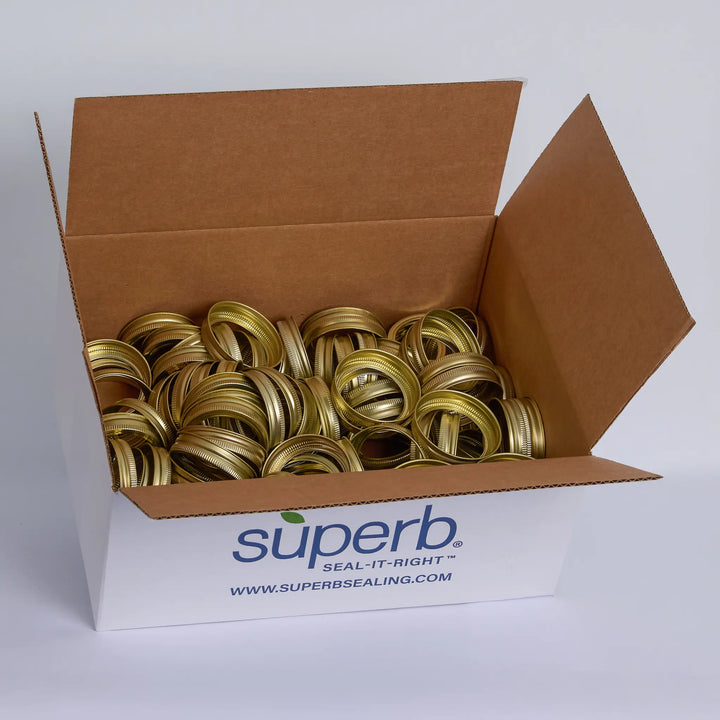 Box of gold canning bands with 'Super Canning' branding on a white background