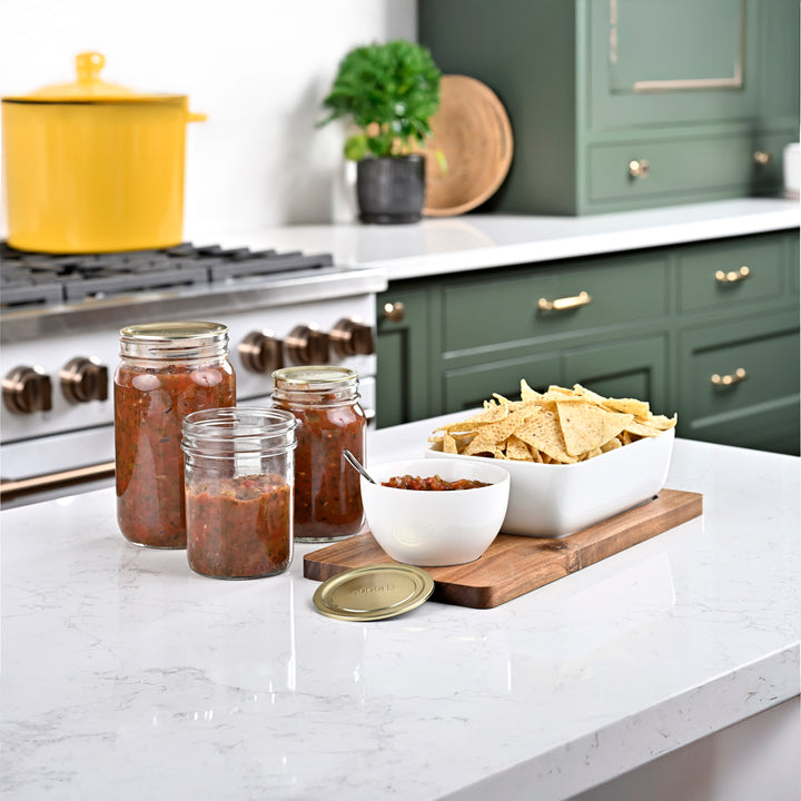 Assorted sizes of Superb canning jars Canning jar with airtight lid High-quality canning jars for food storage Sunlit countertop with filled canning jars Regular mouth jars filled with homemade salsa