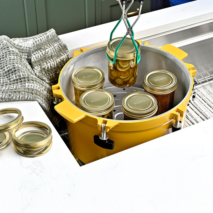 Wide mouth glass canning jar with metal lid from Superb Superb brand wide mouth mason jars stacked neatly High-quality canning jars for food storage Pickled cucumbers sealed in wide mouth jar Soup stored in a Superb regular mouth jar Superb jars supporting sustainable food prep